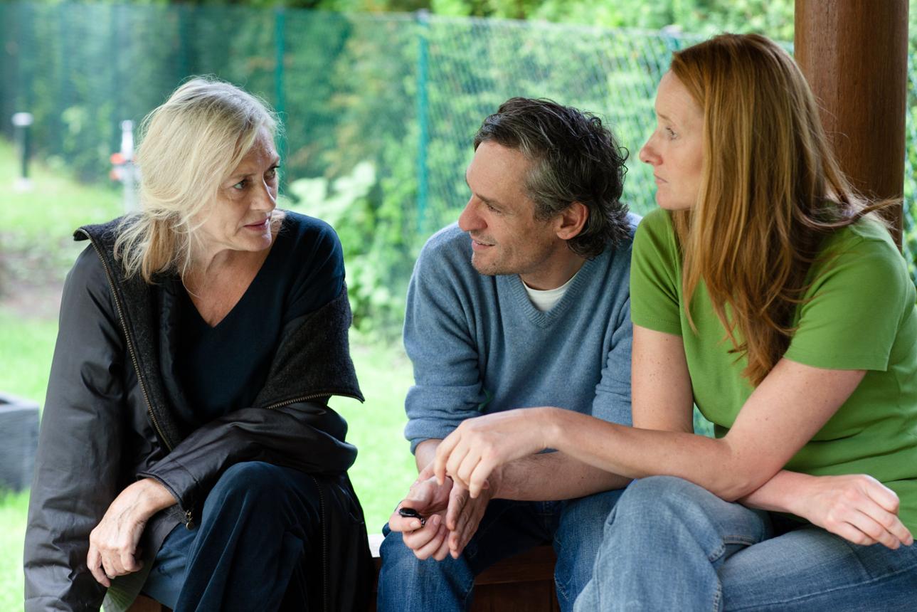 Senior woman with adult children sitting together